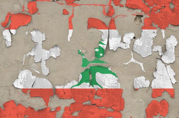 Lebanon flag depicted in paint colors on old obsolete messy concrete wall closeup. Textured banner on rough background