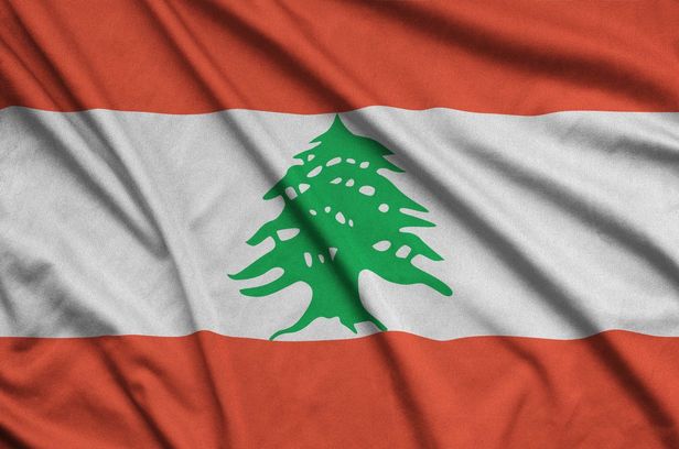 Lebanon flag is depicted on a sports cloth fabric with many folds. Sport team banner